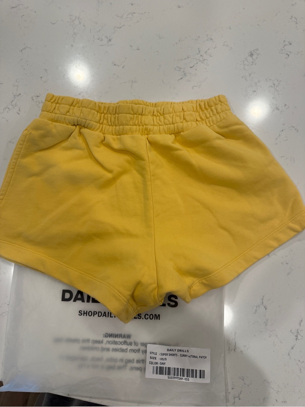 Daily Drills Sunny Yellow with Tonal Patch Super Shorts. XS/S